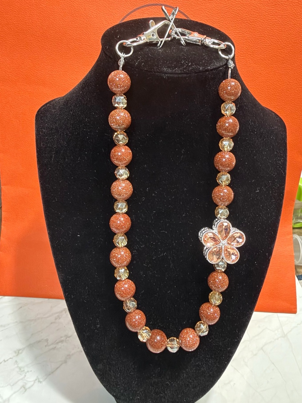 Sparkling Orange Bead Bag Strap with Flower Accent